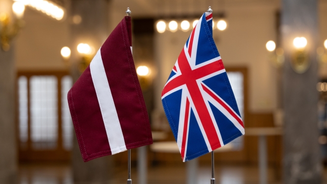 Latvian and UK flags on the table